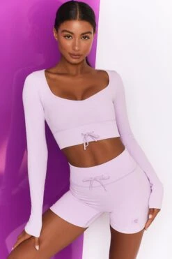 Time Check Ribbed Long Sleeve Crop Top In Lilac 13 Time Check Ribbed Long Sleeve Crop Top In Lilac -Sculpt Sets Body bt0301 bt0306 2 move it time check lilac high waist draw string ribbed cycle shorts long sleeved strap crop top 3