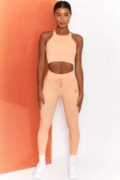 Feel Your Power Ribbed Racer Crop Top In Peach -Sculpt Sets Body bt0302 bt0304 1 energise peach ribbed drawstring workout joggers feel your power ribbed workout top 3