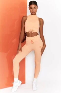 Miles Ahead Ribbed High Neck Crop Top In Peach -Sculpt Sets Body bt0305 bt0302 1 energise peach ribbed drawstring workout joggers mile ahead ribbed work out crop top 2