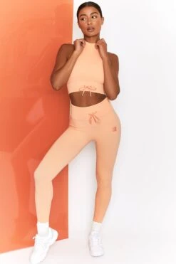 Miles Ahead Ribbed High Neck Crop Top In Peach -Sculpt Sets Body bt0305 bt0302 2 energise peach ribbed drawstring workout joggers mile ahead ribbed work out crop top 2