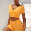 Gradient Scoop Neck Ruched Crop Top In Light Orange 1 Gradient Scoop Neck Ruched Crop Top In Light Orange -Sculpt Sets Body bt0361 bt0366 1 gradient flash light orange scrunched front short sleeve crop top high waist shorts sportswear set 4
