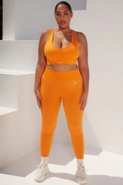Surge Curved Waist Seamless Leggings In Orange 19 Surge Curved Waist Seamless Leggings In Orange -Sculpt Sets Body bt0364 bt0365 10 surge orange leggings beam light crop top 1